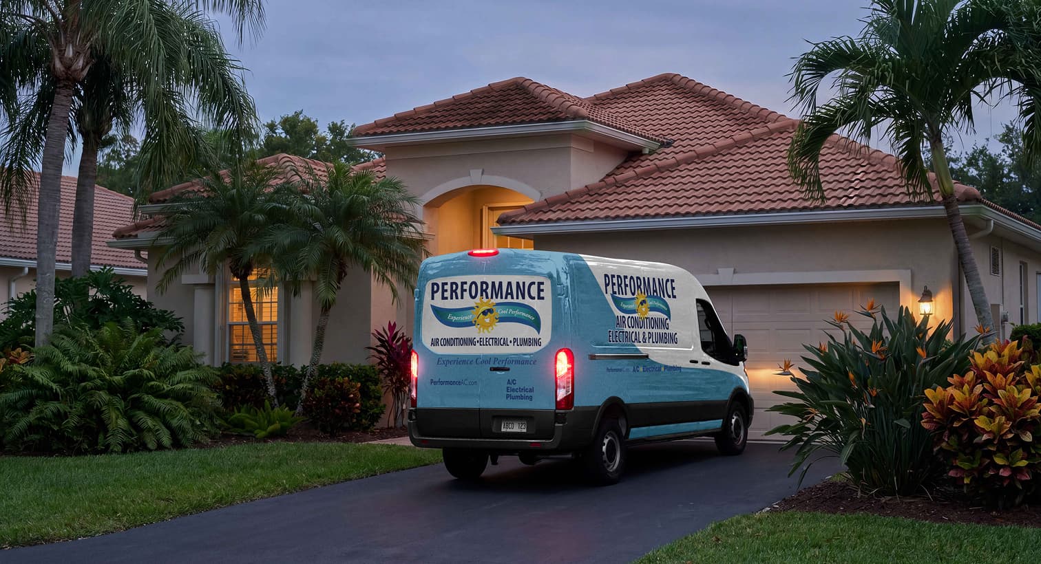A Performance service van parked in a residential driveway at night, arriving to provide 24/7 emergency heating repair services.